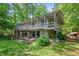 Large backyard features a covered patio, swing set, lush greenery and mature trees at 4501 Zebulon Rd, Zebulon, NC 27597