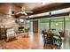 Spacious living room featuring a stone fireplace, wood ceiling, large windows and an open dining area at 4501 Zebulon Rd, Zebulon, NC 27597