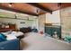 Cozy living room with a fireplace, exposed wooden beams and a comfortable seating area at 4501 Zebulon Rd, Zebulon, NC 27597