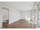 Unfurnished bedroom with modern gray interior, vinyl flooring, and glass sliding door at 4607 Mint Leaf Ln, Raleigh, NC 27612