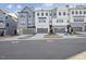 Exterior view of modern townhomes with gray siding, multi-pane windows, and garages at 4607 Mint Leaf Ln, Raleigh, NC 27612
