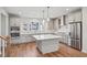 Modern kitchen with stainless steel appliances, quartz countertops, and a kitchen island at 4607 Mint Leaf Ln, Raleigh, NC 27612
