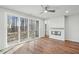 Bright living room with hardwood floors, ceiling fan, fireplace, and large sliding glass doors to the outside at 4607 Mint Leaf Ln, Raleigh, NC 27612
