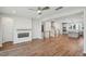 Open concept living room with hardwood floors, fireplace, and stairs leading to the second floor at 4607 Mint Leaf Ln, Raleigh, NC 27612