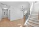 Bright entryway with modern light fixtures, stairs, and hardwood floors at 5049 Lundy Dr # 101, Raleigh, NC 27606