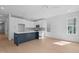 Bright, open kitchen featuring white cabinets, a blue island, and stainless steel appliances at 5049 Lundy Dr # 101, Raleigh, NC 27606