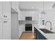 A spacious kitchen with white cabinets, stainless appliances and light hardwood floors at 5049 Lundy Dr # 101, Raleigh, NC 27606