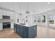 Bright kitchen featuring a large island with a sink, stainless steel appliances and wood floors at 5049 Lundy Dr # 101, Raleigh, NC 27606