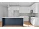 Kitchen with a large island, white cabinets, stainless steel appliances and modern finishes at 5049 Lundy Dr # 101, Raleigh, NC 27606