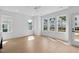 Open living room features light hardwood floors and large windows providing abundant natural light at 5049 Lundy Dr # 101, Raleigh, NC 27606