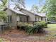 Backyard featuring a wooden deck with access to windows and lush green surroundings at 5109 Knaresborough Rd, Raleigh, NC 27612