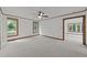 Spacious bedroom with neutral carpet, wood trim, and a ceiling fan at 5109 Knaresborough Rd, Raleigh, NC 27612