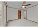 Bright bedroom with carpet, wood trim, ceiling fan, and a closet at 5109 Knaresborough Rd, Raleigh, NC 27612