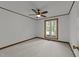 Bedroom showcasing carpet, wood trim, ceiling fan, and window with backyard views at 5109 Knaresborough Rd, Raleigh, NC 27612