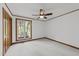 Cozy bedroom highlighting a ceiling fan, wood trim, and carpet at 5109 Knaresborough Rd, Raleigh, NC 27612