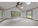 Spacious bedroom with neutral carpet, wood trim, skylights, and lots of natural light at 5109 Knaresborough Rd, Raleigh, NC 27612