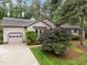 Inviting exterior of home, showcasing attached garage and well-maintained landscaping at 5109 Knaresborough Rd, Raleigh, NC 27612