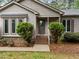 Close-up of front entrance with decorative shrubbery, stairs and modern door at 5109 Knaresborough Rd, Raleigh, NC 27612
