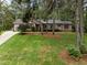 Charming ranch home with lush front lawn and mature trees creating a serene curb appeal at 5109 Knaresborough Rd, Raleigh, NC 27612