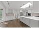 Bright kitchen featuring marble countertops, stainless steel appliances, and a skylight at 5109 Knaresborough Rd, Raleigh, NC 27612