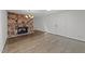 Cozy living room featuring a stone fireplace, hardwood floors, and ample natural light at 5109 Knaresborough Rd, Raleigh, NC 27612
