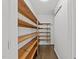 Walk-in pantry featuring wooden shelving for ample storage at 5109 Knaresborough Rd, Raleigh, NC 27612