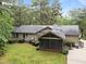 Backyard view featuring a screened-in porch, a wooden deck, and lush landscaping at 5109 Knaresborough Rd, Raleigh, NC 27612