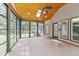 Enclosed sunroom with wood ceiling, skylights, and expansive windows offering outdoor views at 5109 Knaresborough Rd, Raleigh, NC 27612