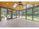 Enclosed sunroom with wood ceiling, skylights, and expansive windows offering outdoor views at 5109 Knaresborough Rd, Raleigh, NC 27612
