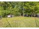Expansive backyard featuring a chicken coop, lush green lawn, and mature trees at 540 W Juniper Ave, Wake Forest, NC 27587