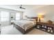 This bedroom features a ceiling fan, two windows, and a large mirror at 540 W Juniper Ave, Wake Forest, NC 27587