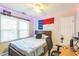 Bedroom featuring a ceiling fan, large window, and an NC state flag at 540 W Juniper Ave, Wake Forest, NC 27587