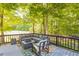 Outdoor deck area with comfortable seating, an outdoor rug, and a cozy fire pit for gatherings at 540 W Juniper Ave, Wake Forest, NC 27587