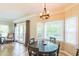 Charming dining area with a round table, large windows, and access to the outdoor deck at 540 W Juniper Ave, Wake Forest, NC 27587