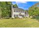 This two-story home includes a well-kept lawn, manicured landscaping, and traditional architectural details at 540 W Juniper Ave, Wake Forest, NC 27587