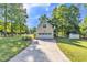 Detached garage with a basketball hoop and a long driveway, offering ample parking space at 540 W Juniper Ave, Wake Forest, NC 27587
