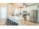 Modern kitchen with white cabinets, stainless steel appliances, and a breakfast bar at 540 W Juniper Ave, Wake Forest, NC 27587