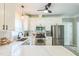 Updated kitchen with stainless steel appliances, white cabinets, and quartz countertops at 540 W Juniper Ave, Wake Forest, NC 27587