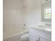 Bathroom featuring a shower-tub combo with a white tiled surround, a sink, and a vanity at 5522 Marthonna Way, Raleigh, NC 27616