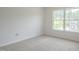 Bright bedroom featuring neutral carpet and a large window allowing natural light at 5522 Marthonna Way, Raleigh, NC 27616