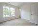 Bedroom with neutral carpet, vaulted ceiling, and a large window providing natural light at 5522 Marthonna Way, Raleigh, NC 27616