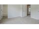 Bedroom featuring neutral carpet and an open doorway to an en-suite bathroom at 5522 Marthonna Way, Raleigh, NC 27616