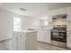 Well-lit kitchen with white cabinets, stainless steel appliances, and an island at 5522 Marthonna Way, Raleigh, NC 27616
