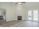 Bright living area with tile fireplace, laminate flooring, and modern ceiling fan at 5522 Marthonna Way, Raleigh, NC 27616