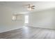 Open-concept living area featuring modern gray floors, neutral walls, and a ceiling fan at 5522 Marthonna Way, Raleigh, NC 27616