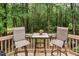 Outdoor deck features a cozy seating area perfect for relaxing and enjoying the surrounding lush greenery at 5629 Yates Garden Ln, Raleigh, NC 27606