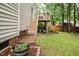 Landscaped backyard with patio and wooden deck is perfect for outdoor entertaining and relaxation at 5629 Yates Garden Ln, Raleigh, NC 27606