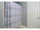 Bathroom features a shower with a decorative paisley shower curtain and a white door at 5629 Yates Garden Ln, Raleigh, NC 27606