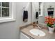 Cozy bathroom with a vessel sink, decorative mirror, and natural light from a window at 5629 Yates Garden Ln, Raleigh, NC 27606