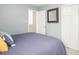 Bedroom featuring blue walls, a carpeted floor, and closet doors at 5629 Yates Garden Ln, Raleigh, NC 27606